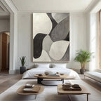 Minimalist geometric art in bedroom, black, white, grey tones.