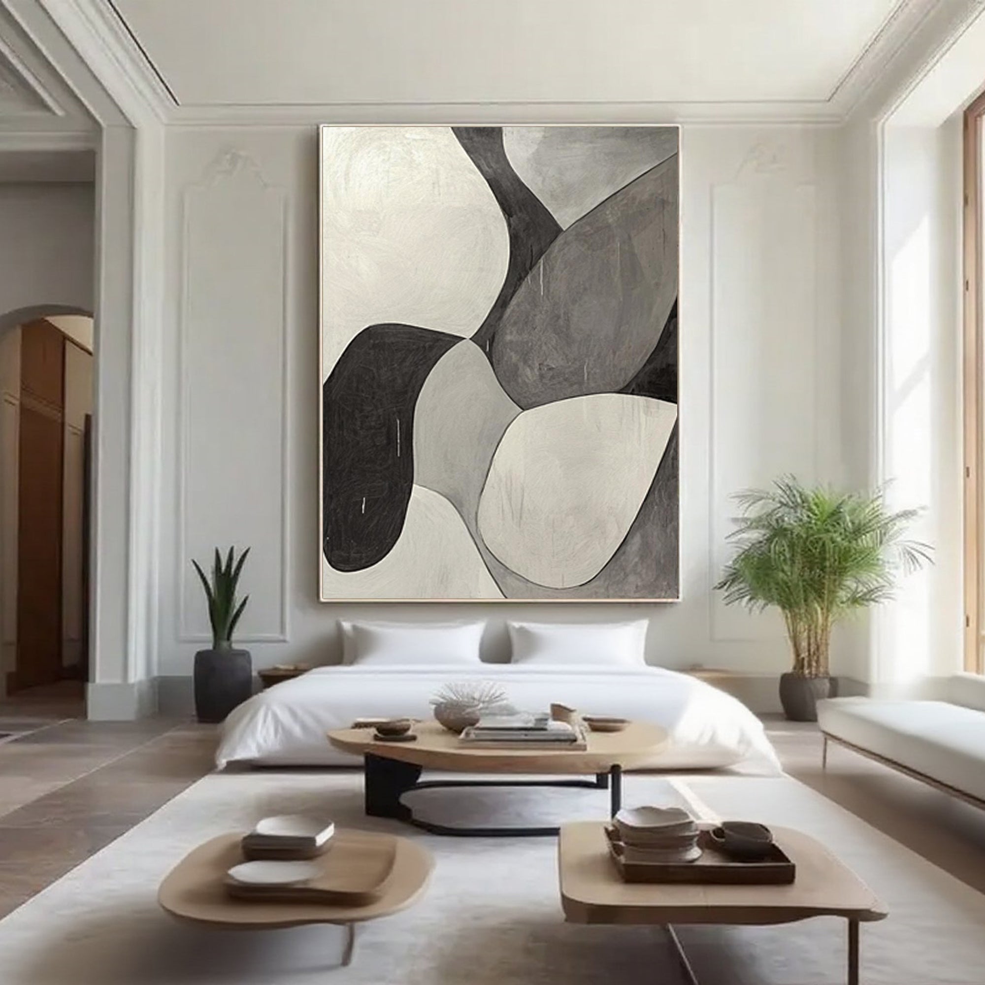 Minimalist geometric art in bedroom, black, white, grey tones.