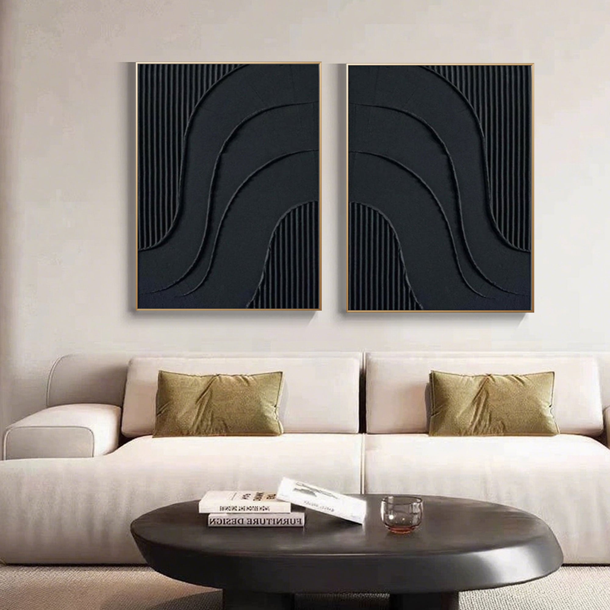 Black minimalist wall art displayed above a couch in a living room.