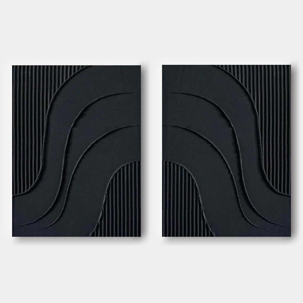 Minimalist black wall art featuring curved reliefs and vertical textures.