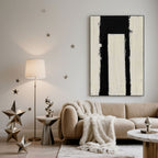 Minimalist geometric Passage wall art in black and white over a sofa.