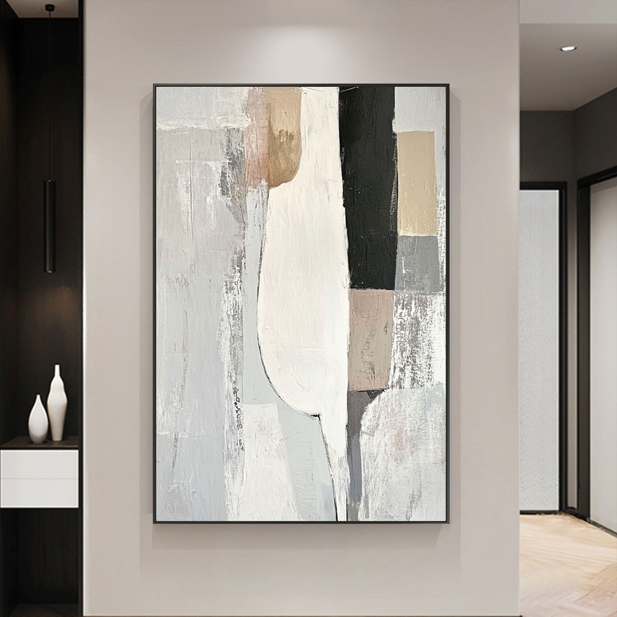 Minimalist geometric wall art in neutral tones of white, beige, and black in living room.