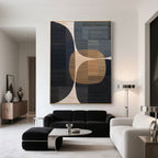 Intersecta geometric art above a black sofa in modern living room
