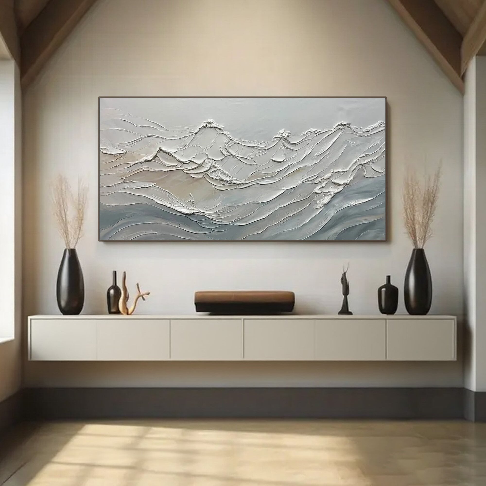 Ocean wave art displayed above a modern console in a living room.