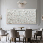 Minimalist floral artwork displayed above a dining table in a modern setting.