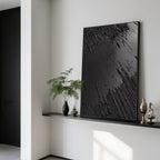 Black Wabi-Sabi canvas art on a shelf with decorative vases.