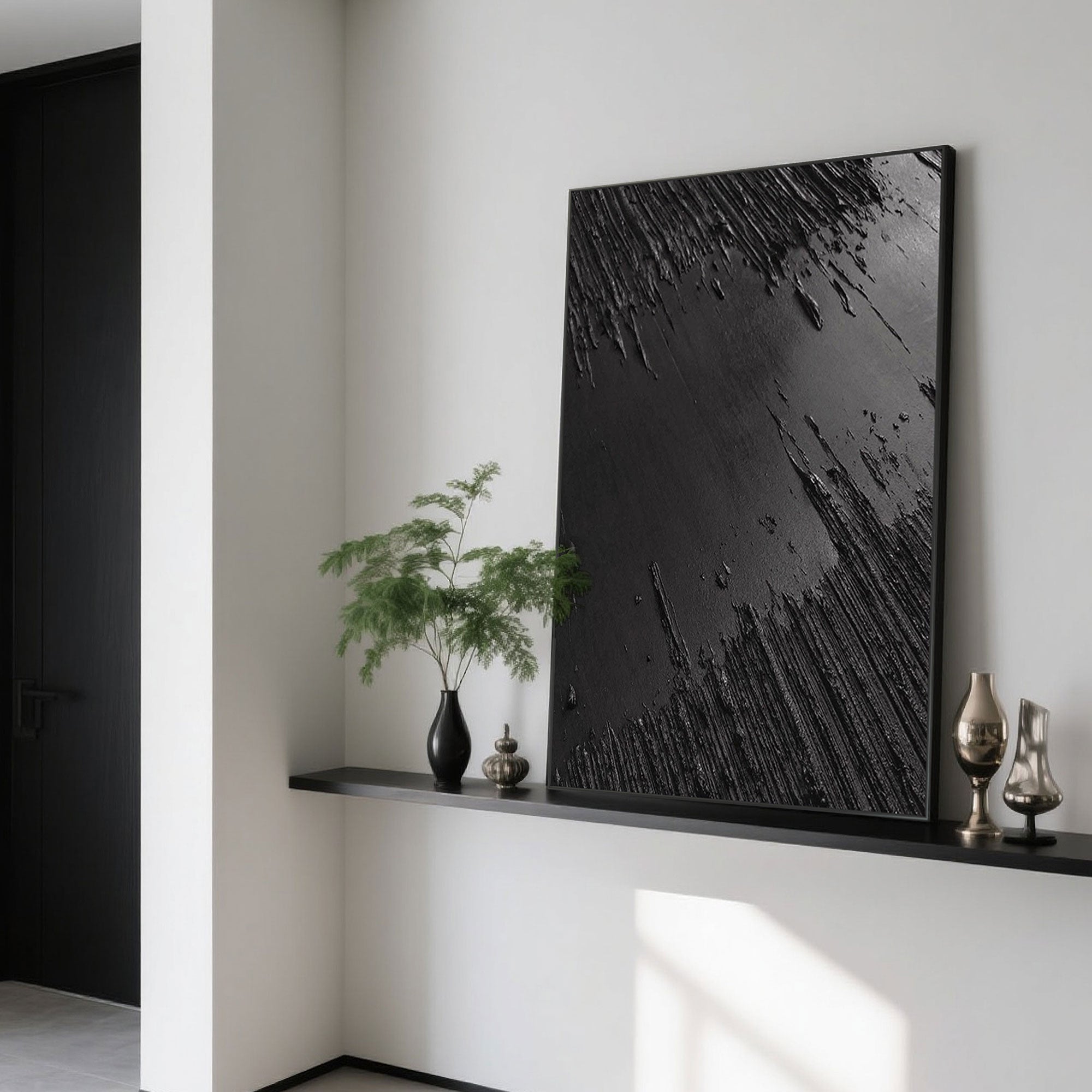 Black Wabi-Sabi canvas art on a shelf with decorative vases.