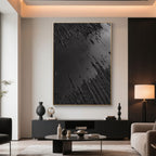 Black canvas art in a living room with a fireplace.