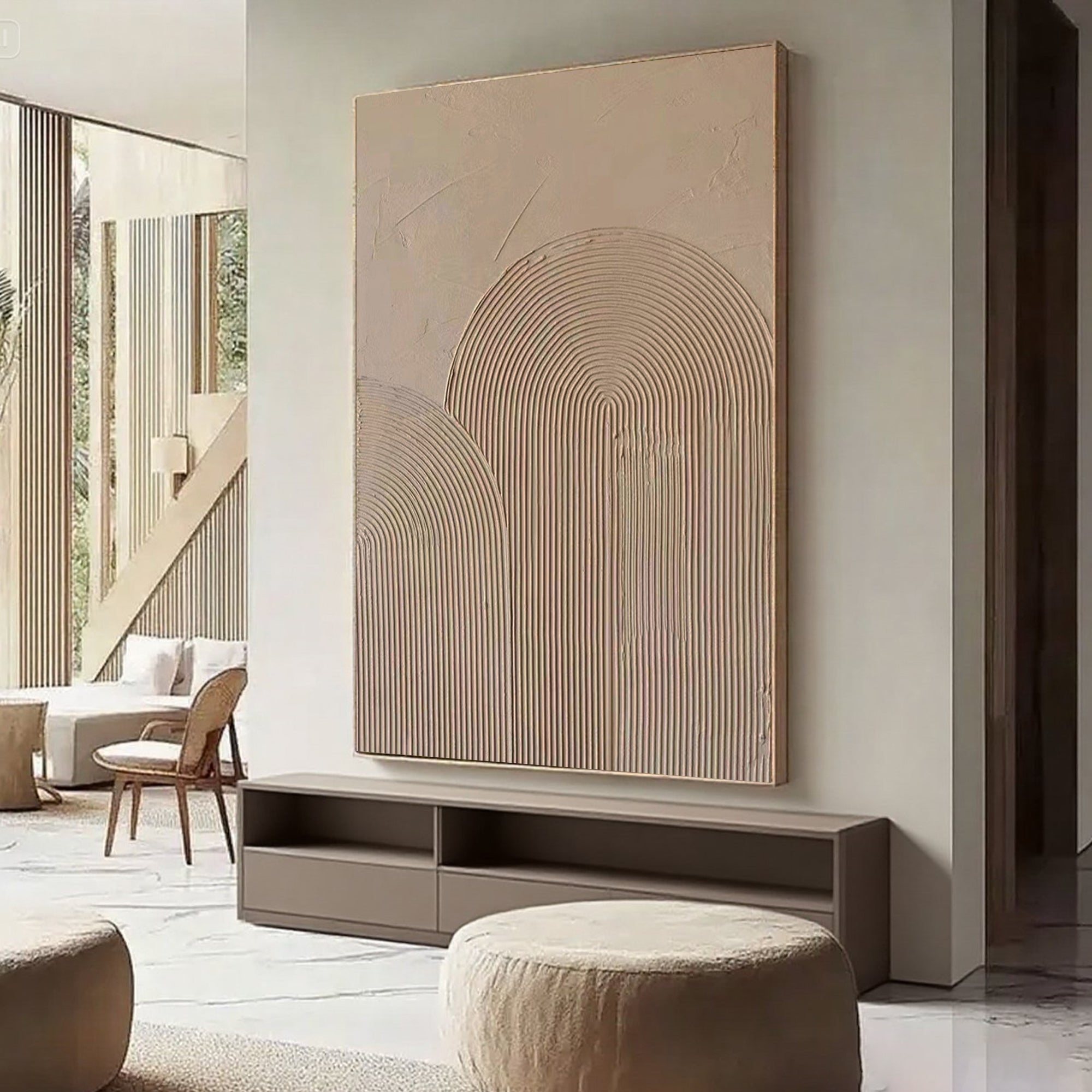 Beige canvas art with arches in a living room mounted above console.
