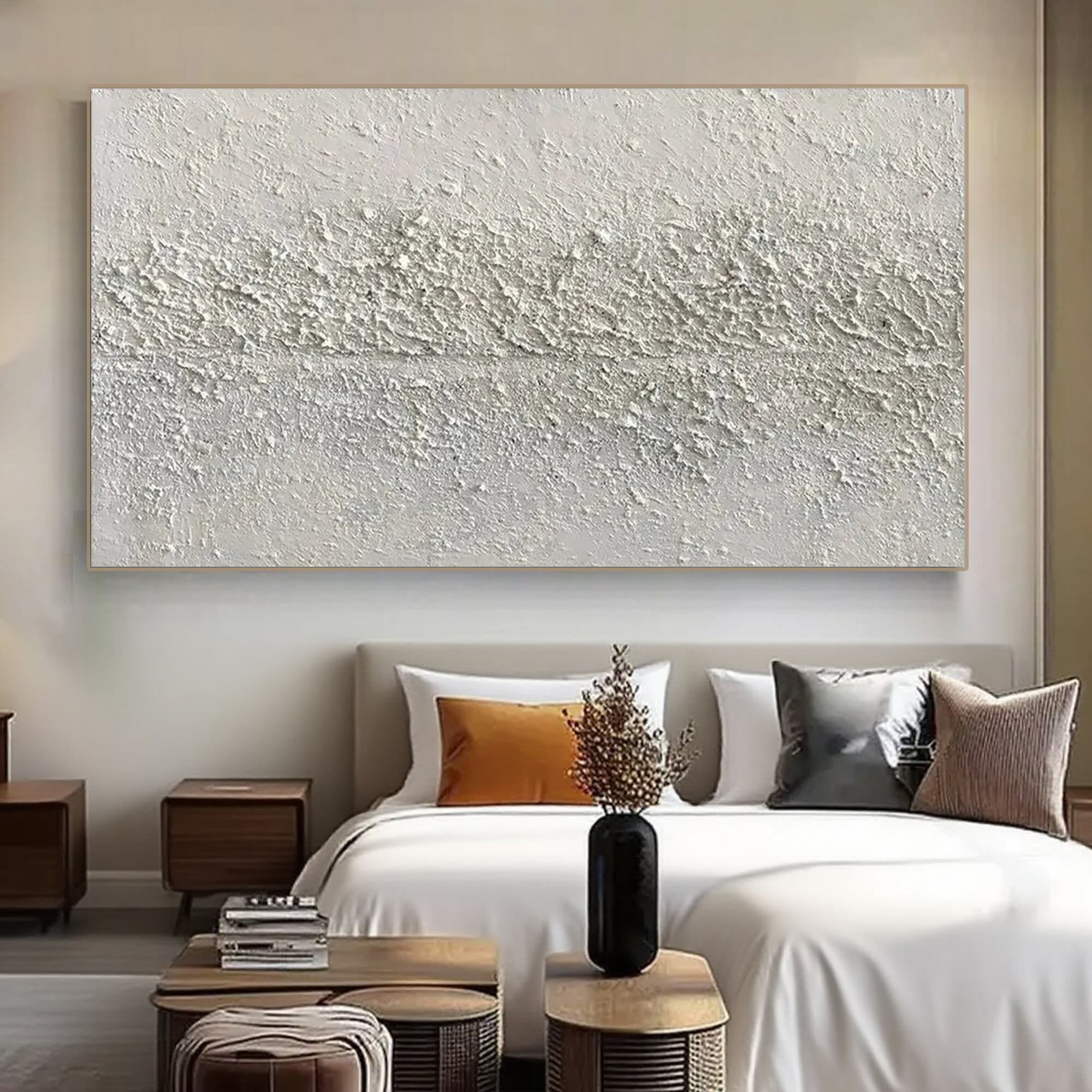 Wabi-sabi art with a light wood frame above a bed in a modern bedroom setting.