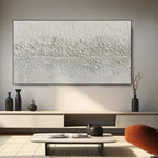 Minimalist canvas art with a sleek black metal frame in a modern living room setting.