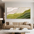 Minimalist abstract wave canvas art 'Verdant Rise' featuring textured green and beige waves, gold frame, in a modern living room with a beige sofa and marble coffee table.