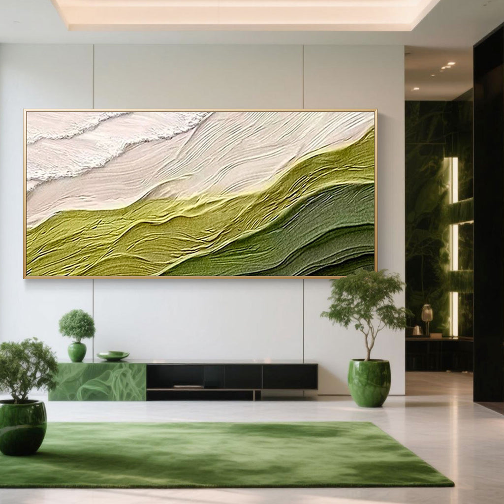 Minimalist abstract wave canvas art 'Verdant Rise' featuring textured green and cream waves, hand-painted on canvas, gold-framed, in a modern living room with green decor accents.