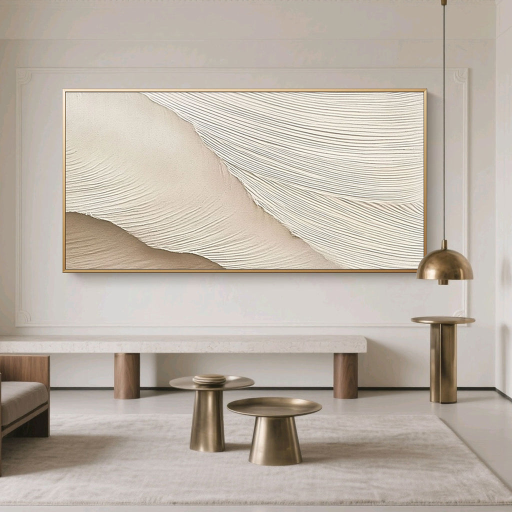 Minimalist Abstract Wave Wall Art – Soft Crest: soft beige and cream textured waves, gold frame, displayed in modern living room with neutral tones and brass accents.