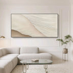 Minimalist abstract wave wall art 'Soft Crest' with textured, layered lines in soft beige and cream tones, displayed in a modern living room with a light gray sofa and glass coffee table.