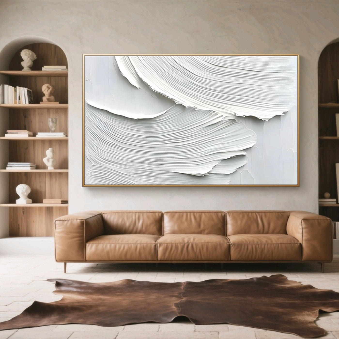 Minimalist abstract waves wall art in white and light gray with textured brushstrokes, displayed in a living room with a brown leather sofa and wooden shelves.