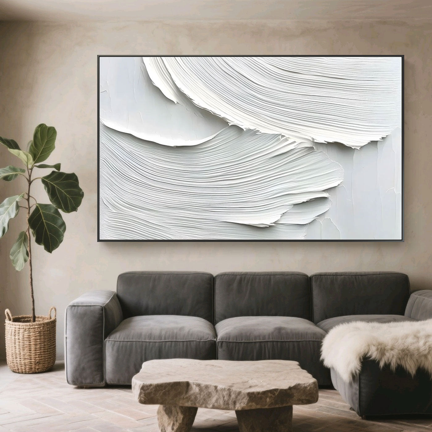 Minimalist Abstract Waves Wall Art – Whispered Drift: hand-painted textured abstract with white and light gray waves, displayed in a modern living room with gray sofa, stone table, and potted plant.