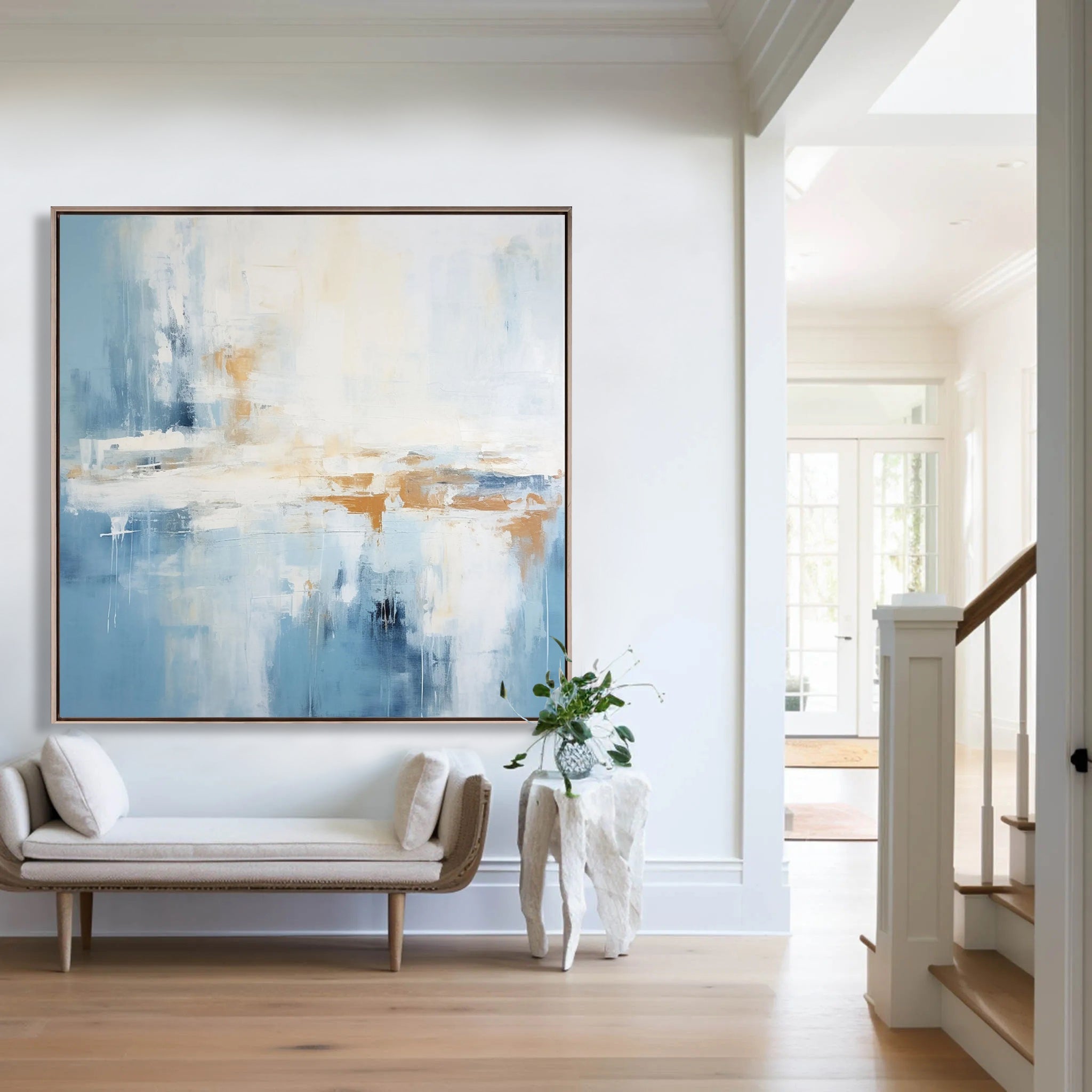 Abstract blue landscape art displayed above a modern bench in a light and airy hallway.