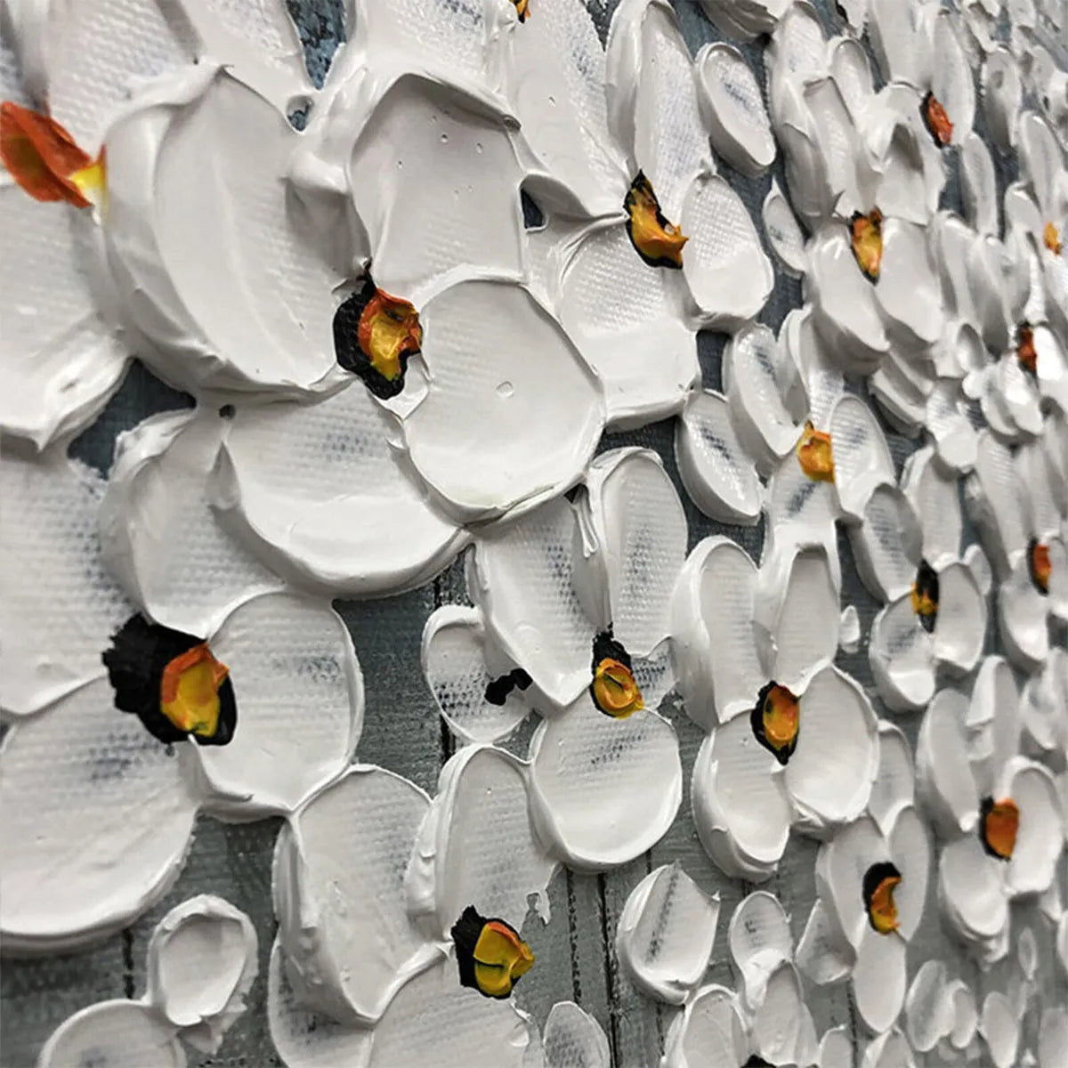Close-up of textured impasto flowers in white with silver accents on the floral painting.