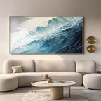 Hand-painted blue wave art in a gold frame above a modern living room.