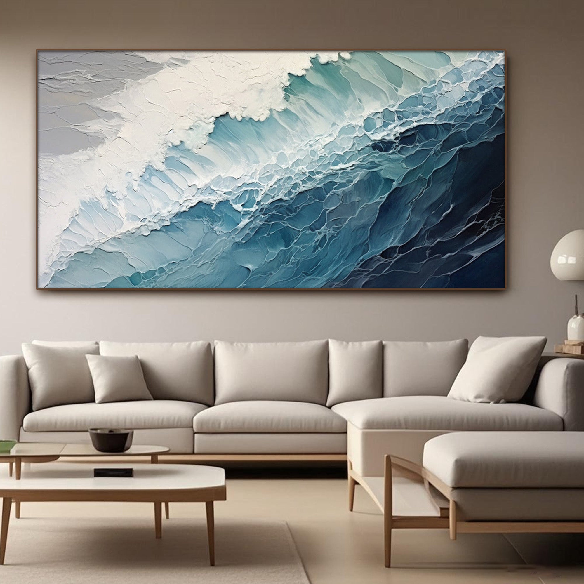Modern coastal artwork in living room setting with beige sectional sofa.
