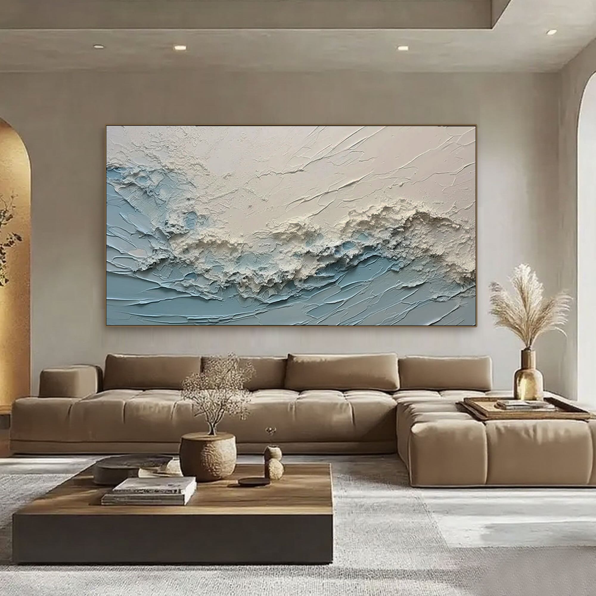 Modern ocean wave art in living room, textured blue painting above sofa.