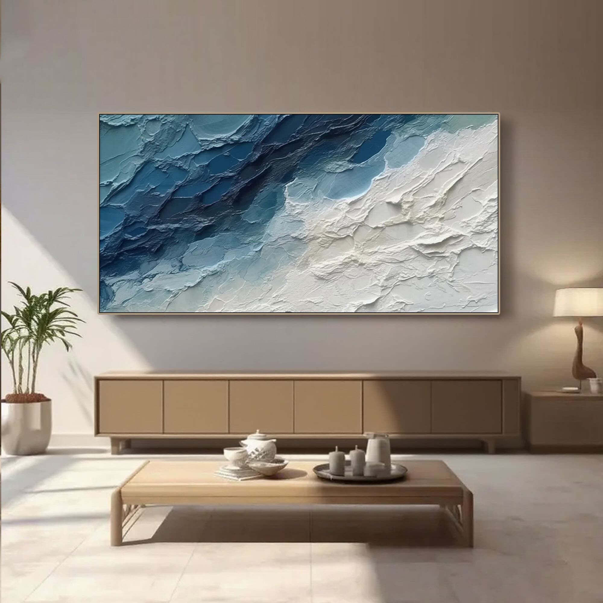 Modern living room featuring abstract ocean art above a console table.