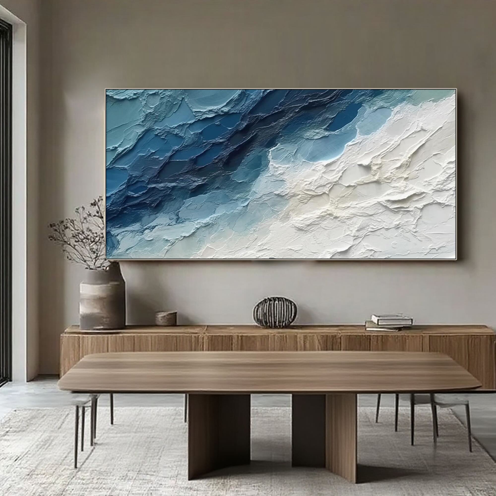 Contemporary dining room with abstract ocean art as focal point.