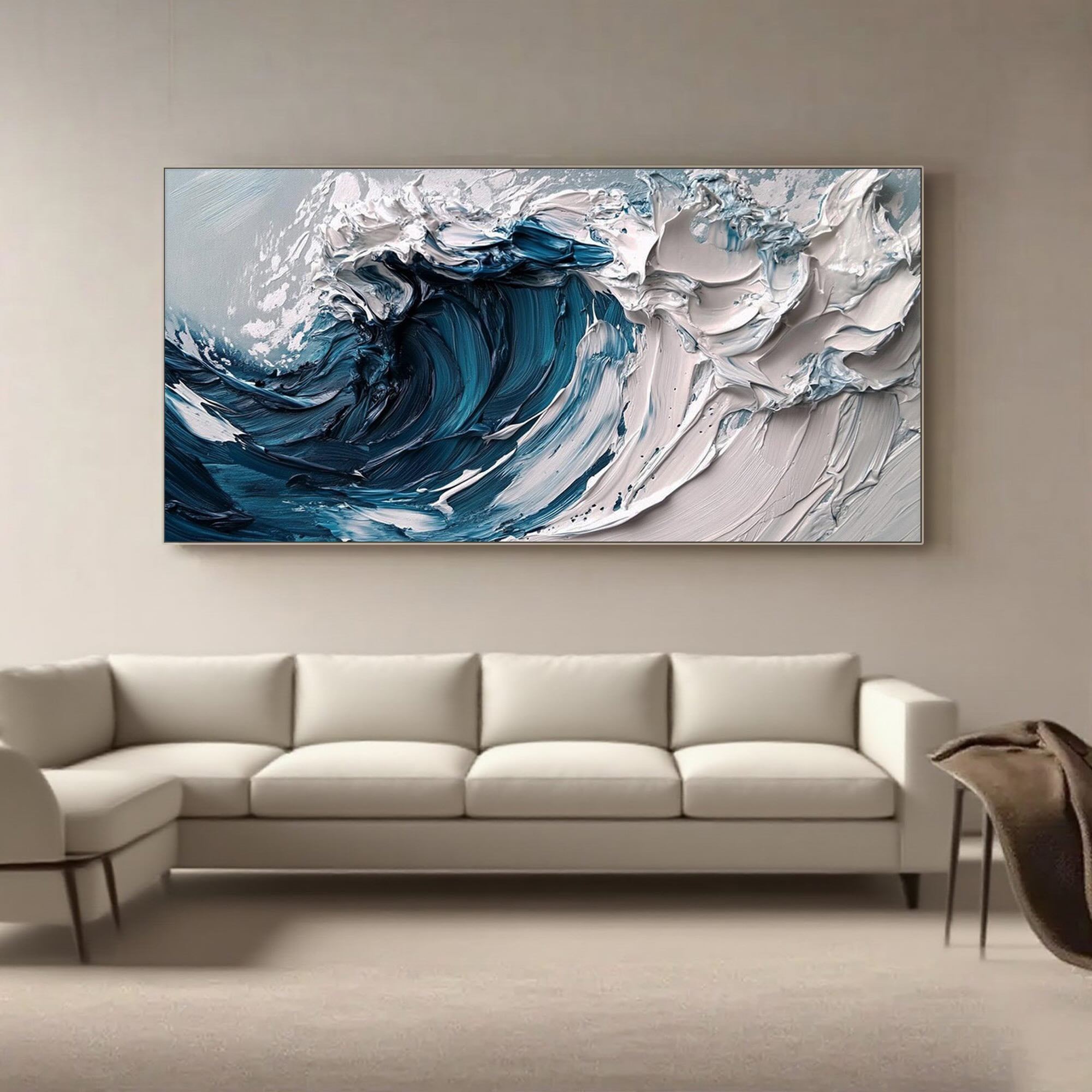 Blue and white abstract wave painting above a modern white sofa.