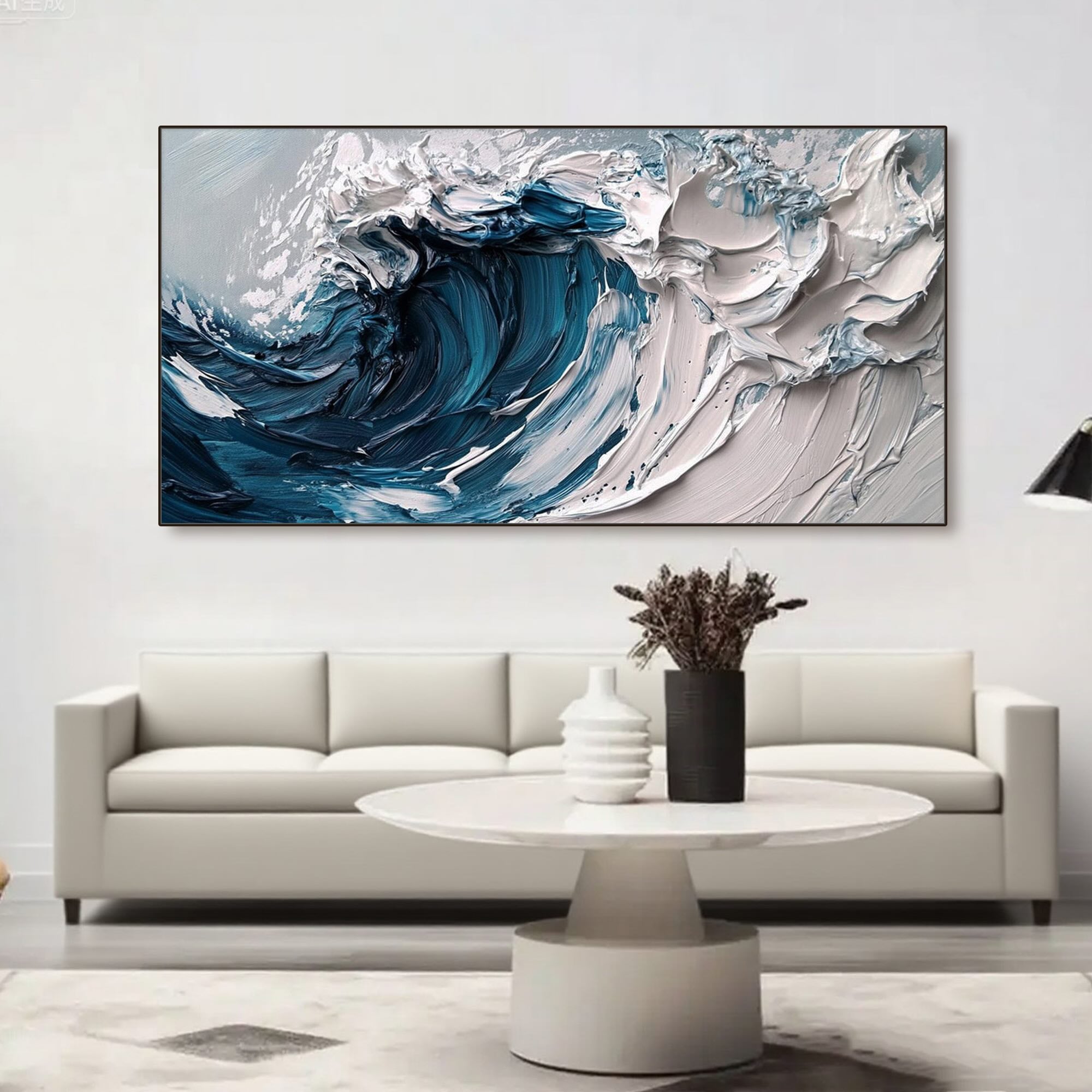 Large abstract ocean wave canvas in a black frame over a sofa.