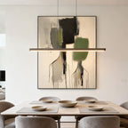 Abstract canvas art with black, green, beige tones above dining table - Lumi Gallery