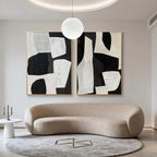 Modern geometric abstract hand-painted wall art in black/white, beige living room with curved sofa