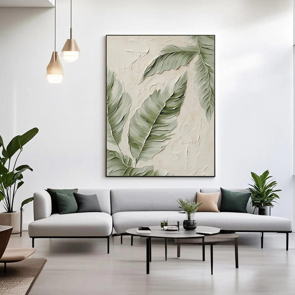 Lumi Gallery modern minimalist botanical canvas art with banana leaves, textured details, mounted on white wall above light gray sofa