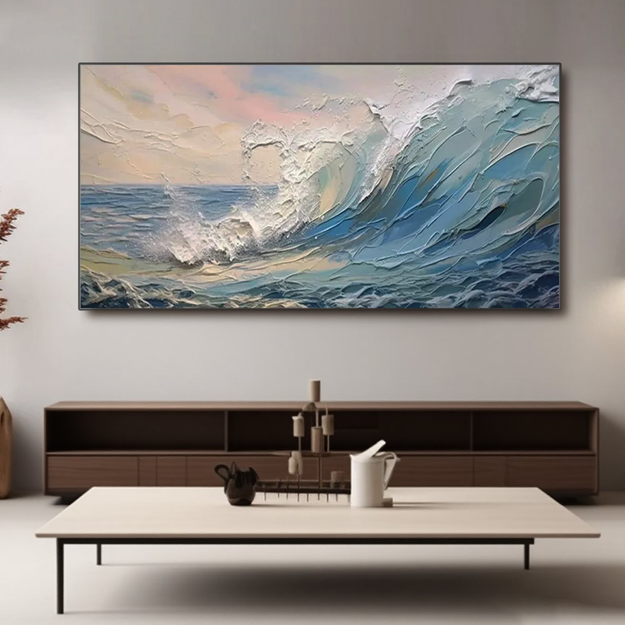 Ocean wave art on canvas above console table in living room setting.