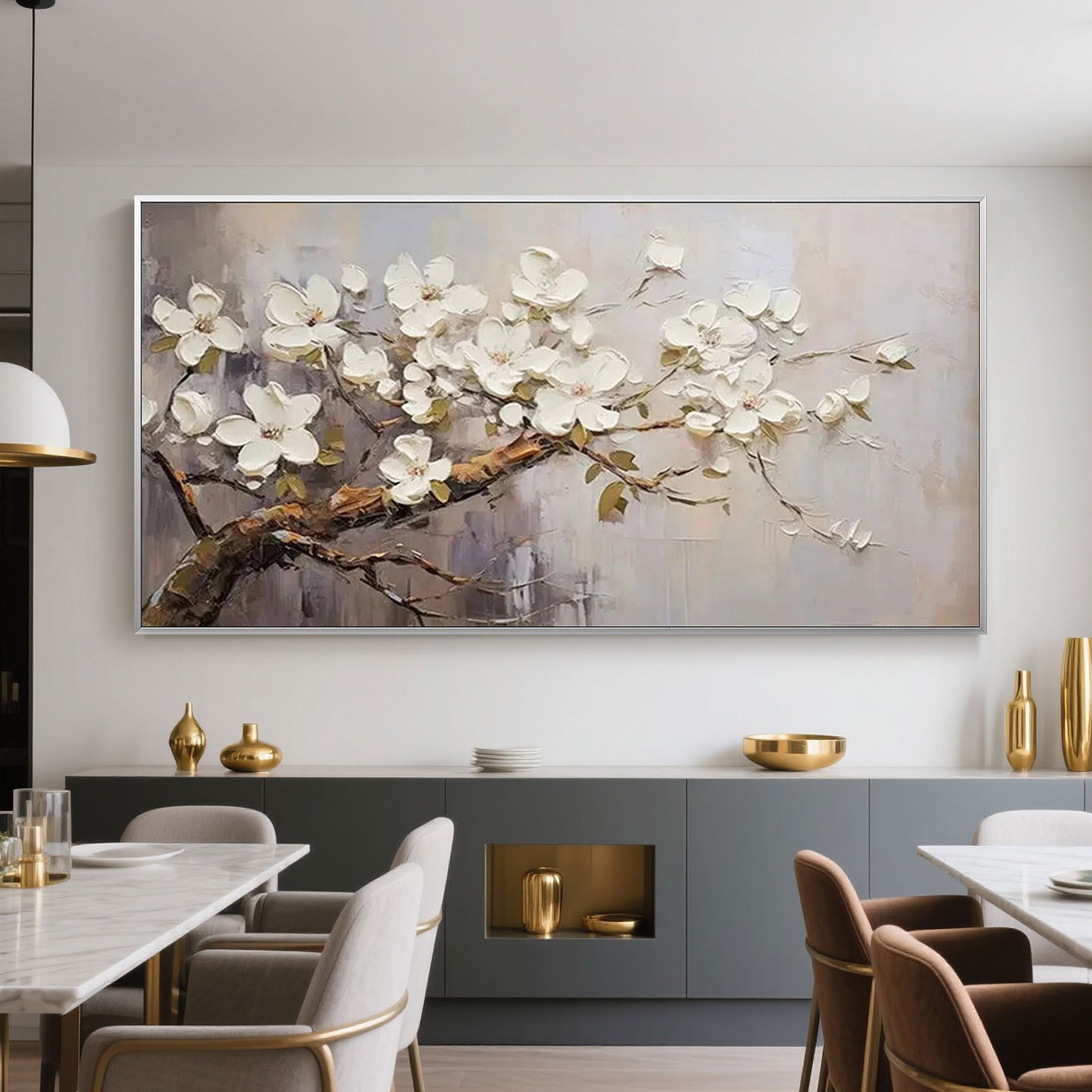Contemporary dining area featuring beige floral art above a gray sideboard.