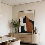 Modern interior with abstract art on the wall, sideboard, and marble table.