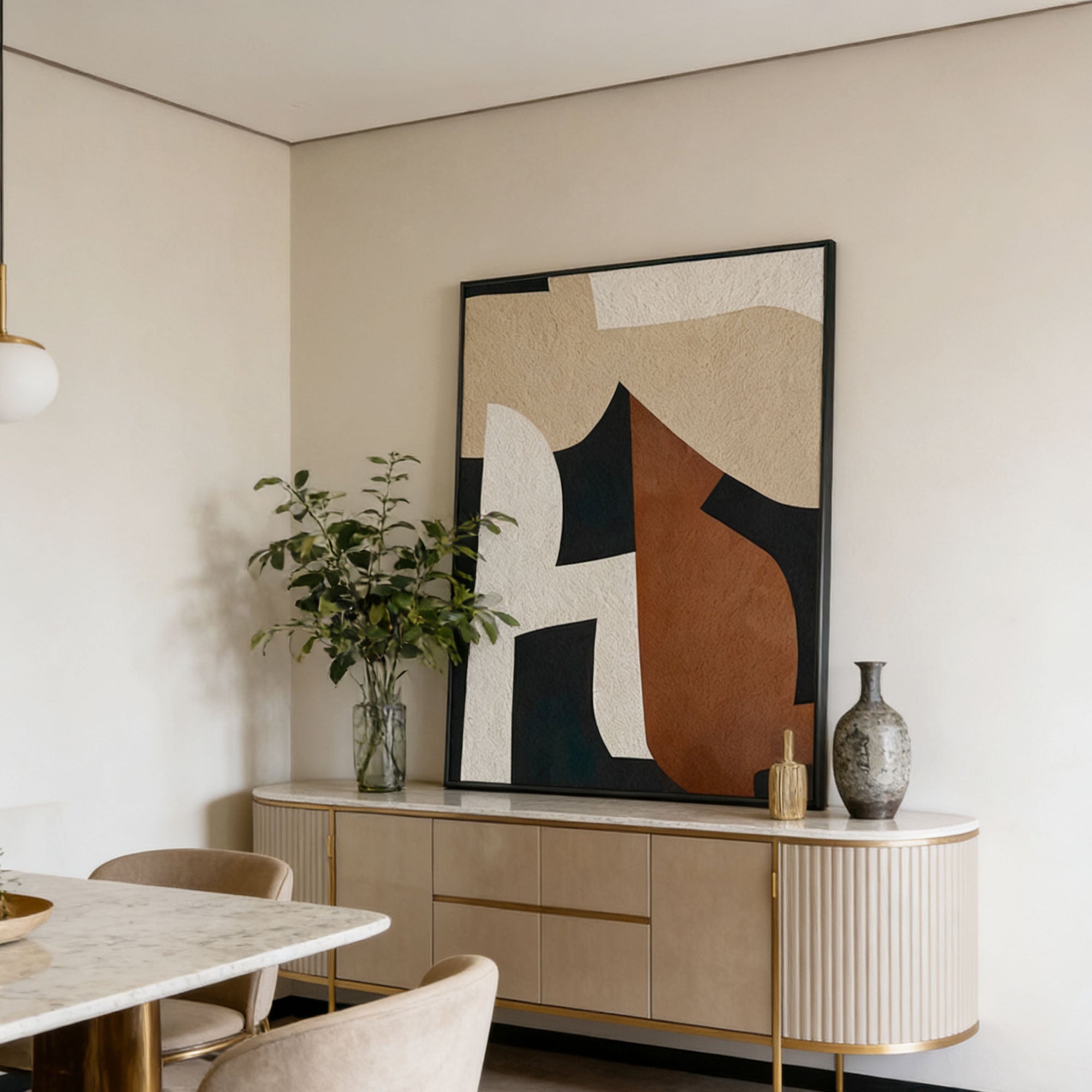 Modern interior with abstract art on the wall, sideboard, and marble table.