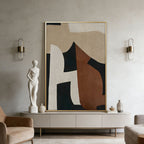 Abstract art piece in a modern living room with a statue and decor items.