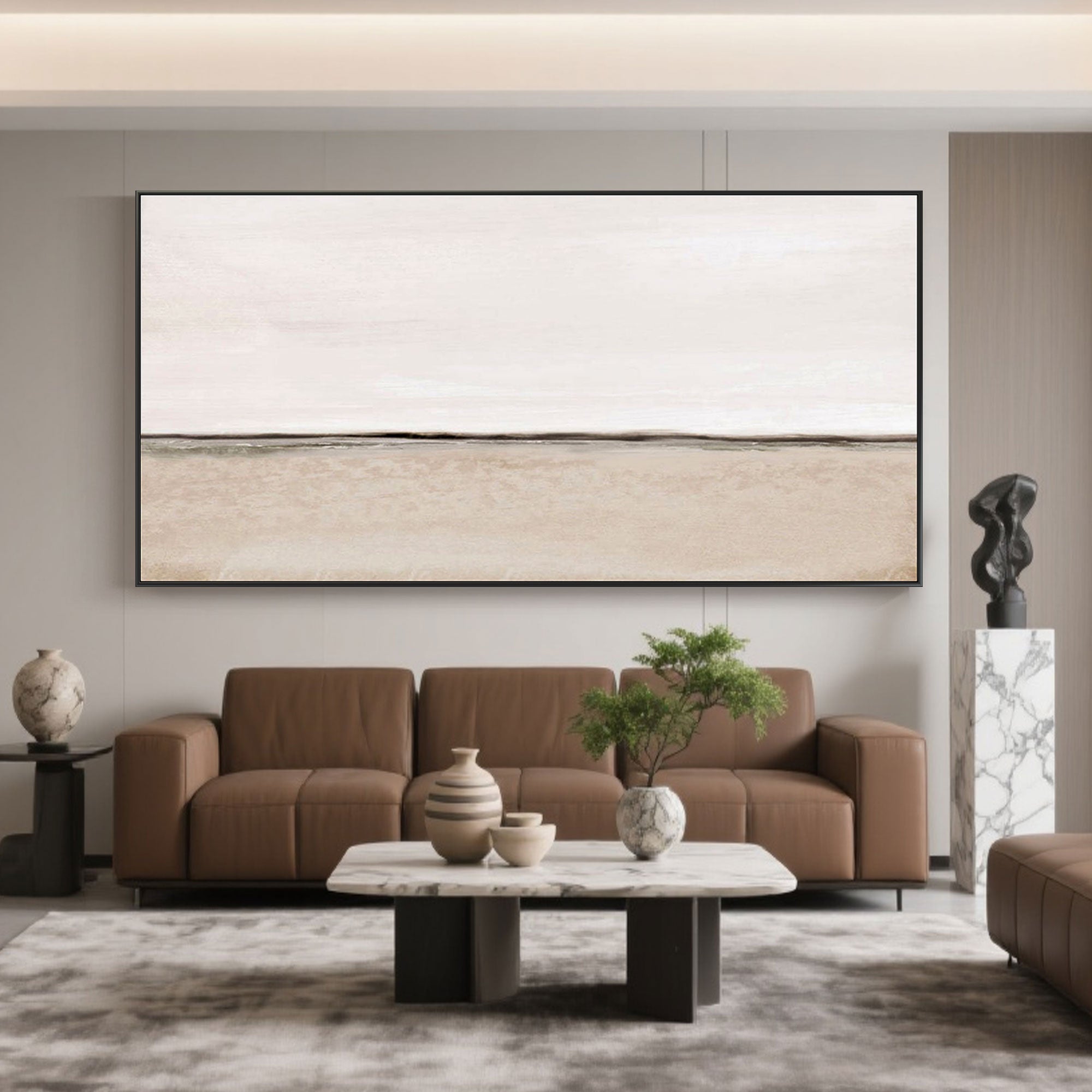 Beige panoramic canvas art above leather sofa in living room setting.