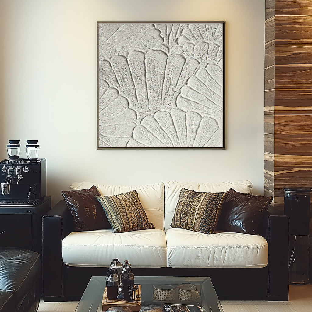 White plaster art texture painting above a white sofa in a living room.