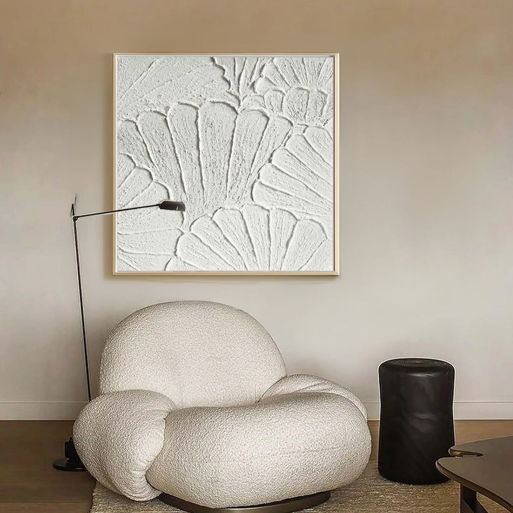 Plaster art texture painting above a chair in a styled room.