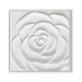 Close-up of a white plaster art texture painting of a rose in a white frame.