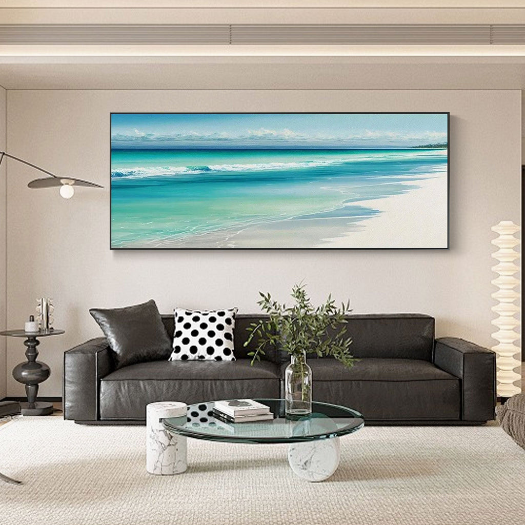 Turquoise shore canvas art with black frame in a living room setting.