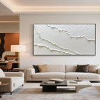 Abstract ocean wall art 'Drift' with black frame above sofa.