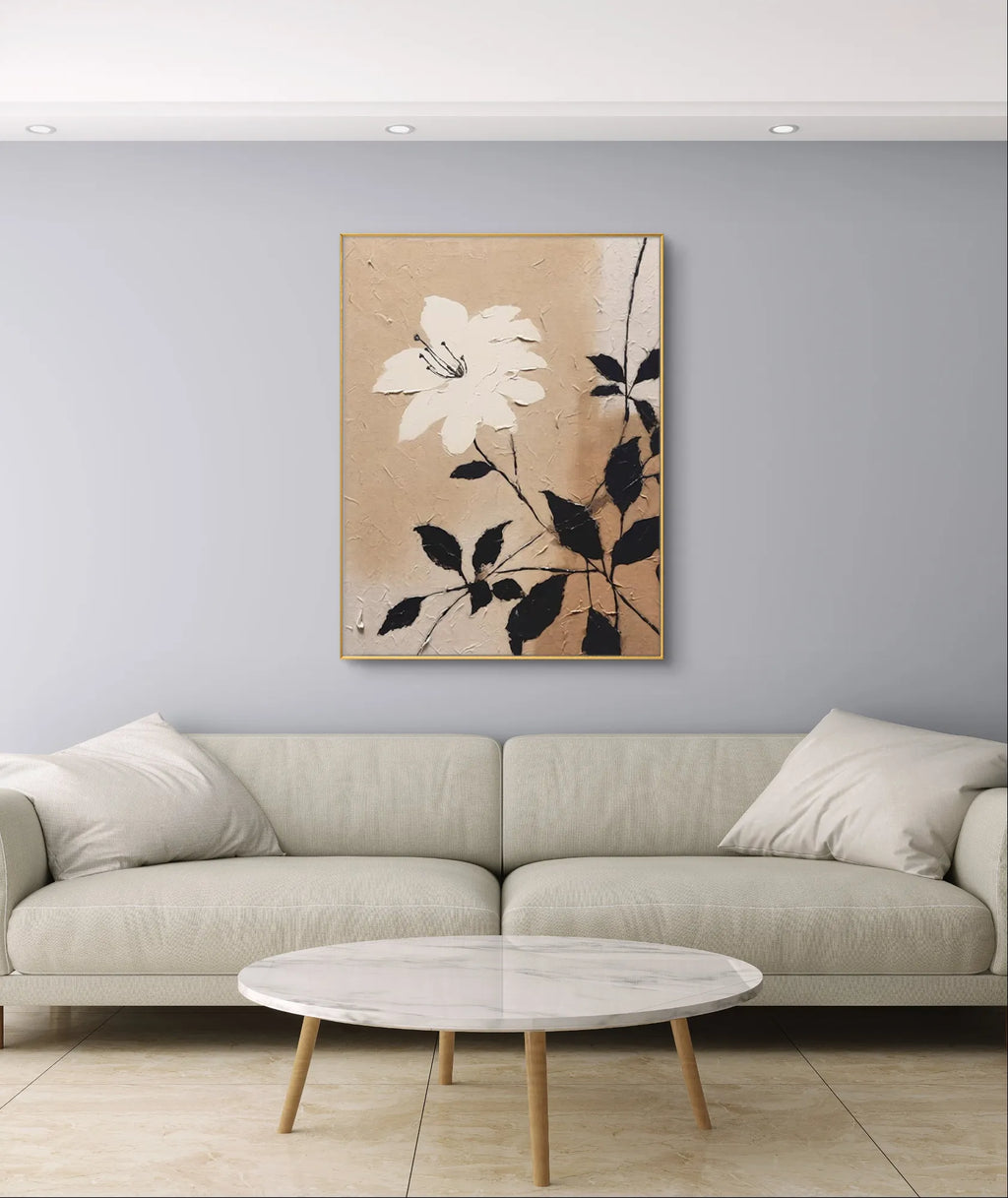 Textured beige floral wall art with a white flower and black leaves on canvas