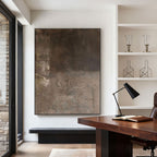 Large minimalist Wabi-Sabi abstract painting with textured earthy brown layers, displayed in a modern office with wooden desk and white shelves.