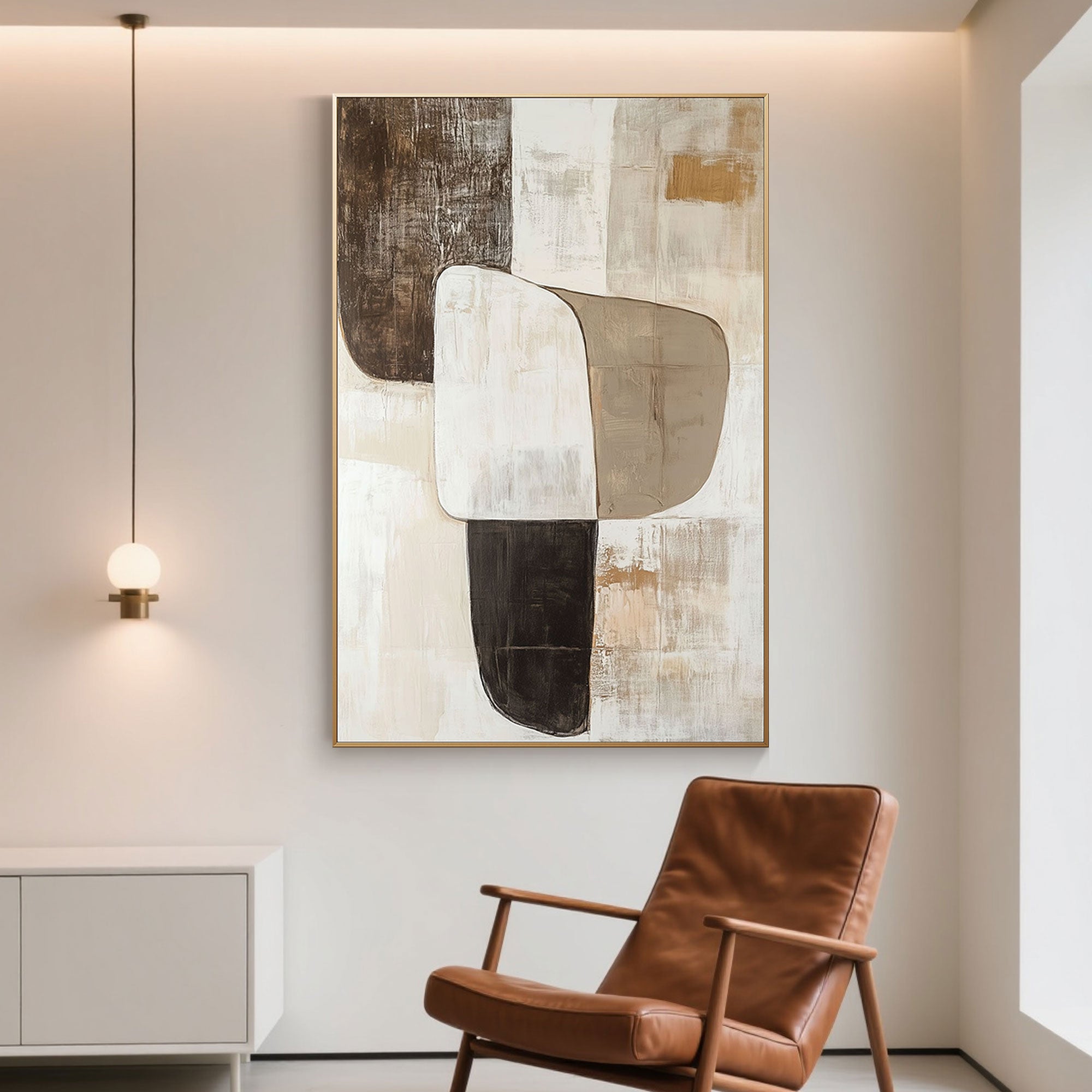 Hand-painted abstract art with gold frame hanging above a brown leather chair.