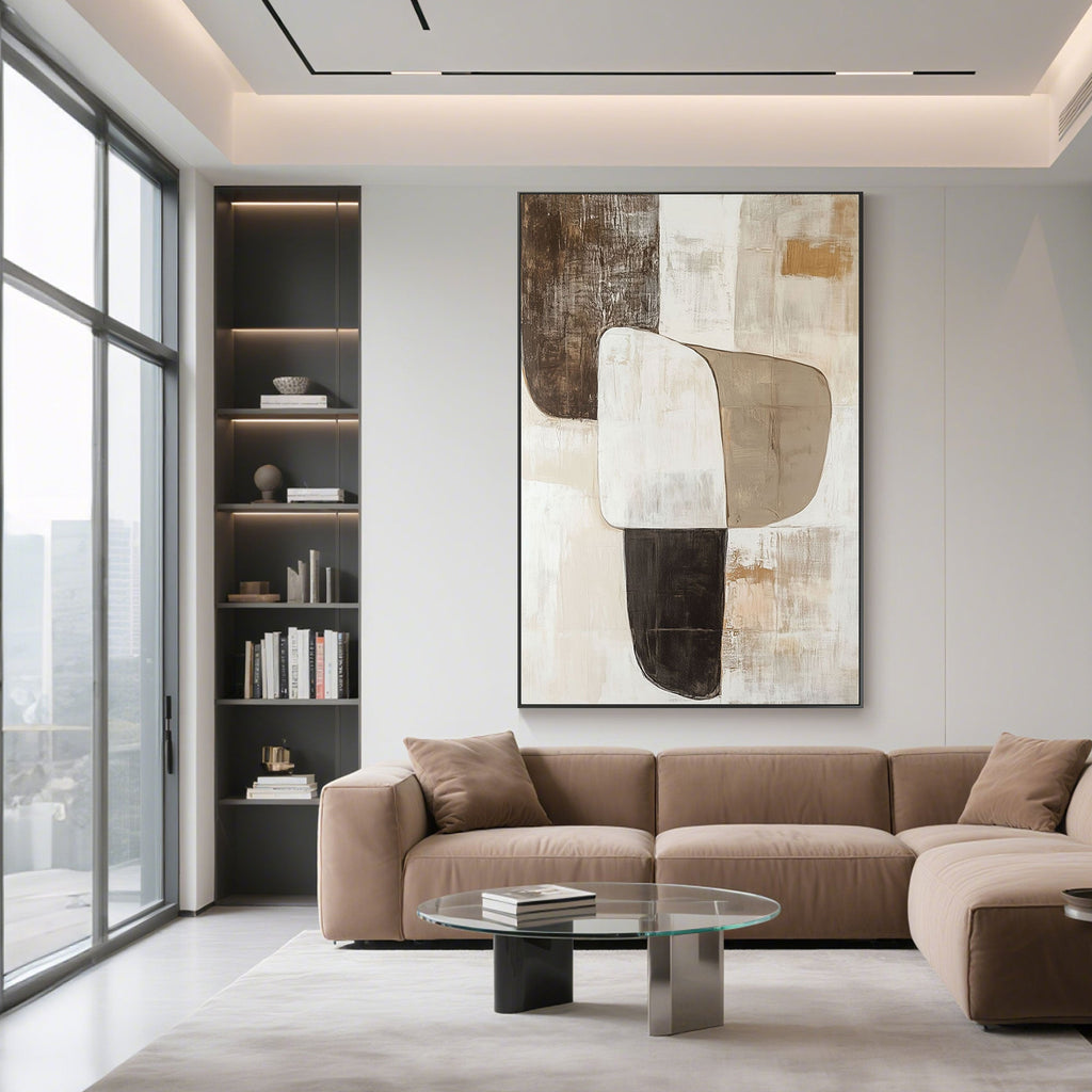 Vertical canvas art in living room with modern brown sofa.