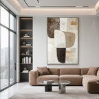 Vertical canvas art in living room with modern brown sofa.