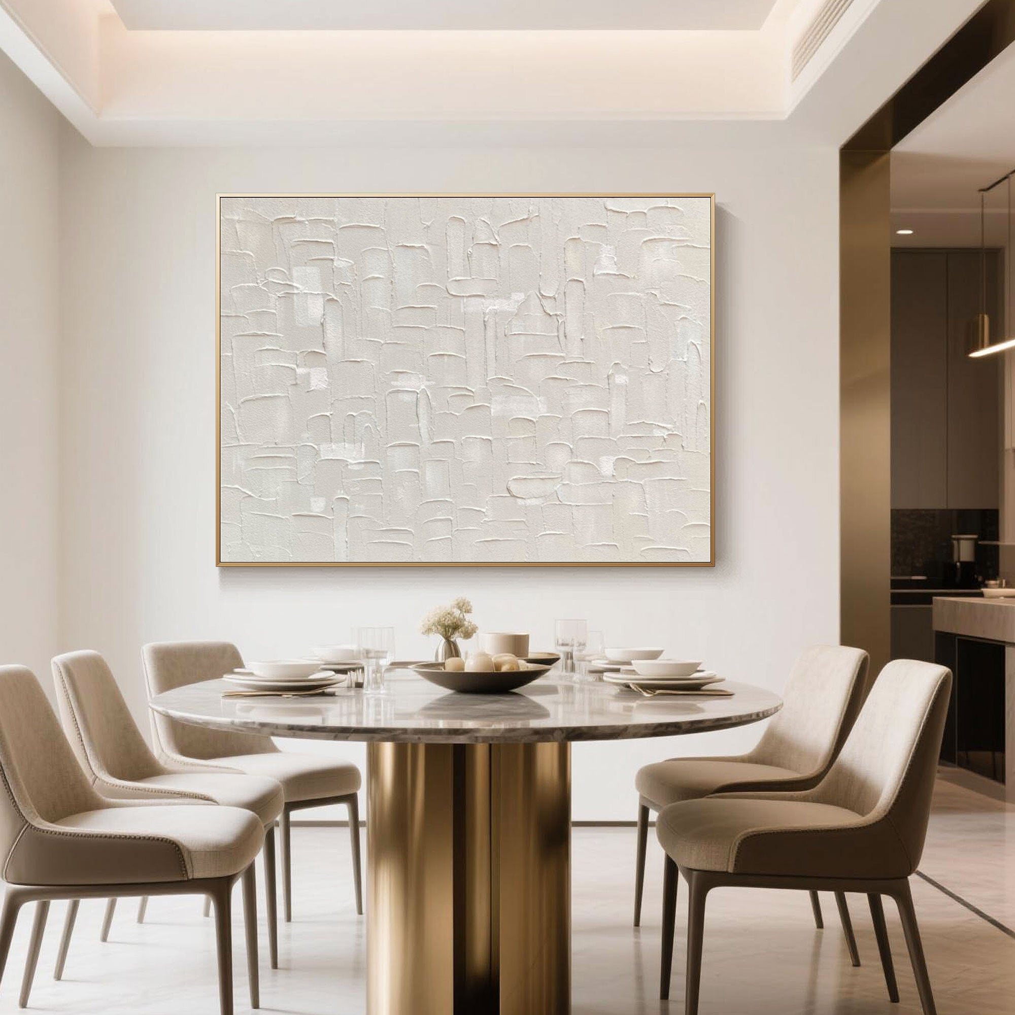 Minimalist beige wall art above a round dining table in a cream-toned room.